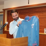 Craig Katinas '93 holds up a vintage Varsity track jacket.