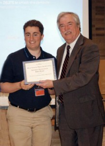Stanner Editor in Chief John Fenner '15 accepts an award for General Excellence from Tablet Editor Ed Wilkinson..